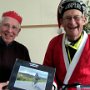 Brian Lowe receiving a '<span style="font-weight:bold; font-style:italic;">collection of photos</span>', presented by Mike Cross, for his contribution to Wednesday Riders as Rides Secretary over many years.